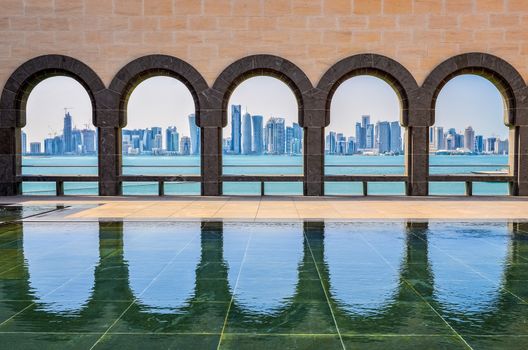 Doha skyline seen through the arches at the Museum of Islamic art, Doha, Qatar