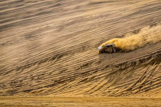 Off-road vehicle driving in the sand desert dunes