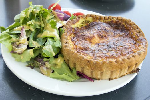 Quiche Lorraine Pasty with Mixed Green and Tomatoes Salad Closeup