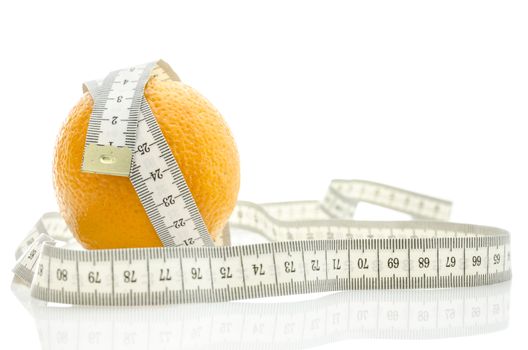 Fresh orange wrapped with measuring tape. Isolated over white background. Dieting concept.