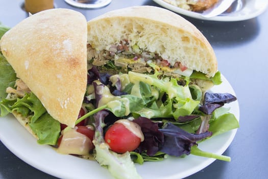 Tuna Salad Sandwich with Ciabatta Bread and Leafy Mixed Green Salad with Tomatoes