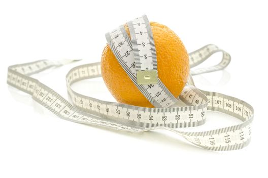 Measuring tape wrapped around orange fruit. Isolated over white background.