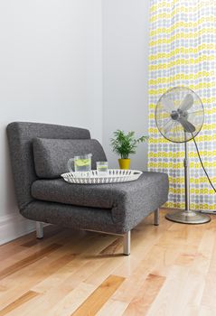 Armchair and electric fan in a contemporary living room.