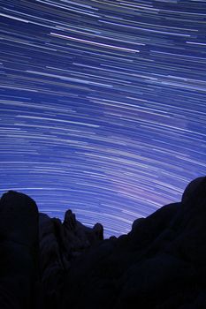 Star Trail Streaks over the Rocks of Joshua Tree Park