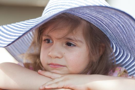 little girl in a big summer hat