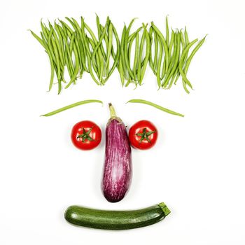 Funny vegetables face on white background