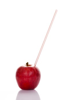 Red apple with straw on white background