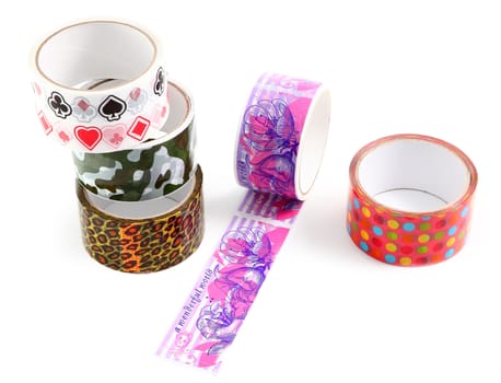 Set of several rolls of colored packing tape with colorful decorative print.