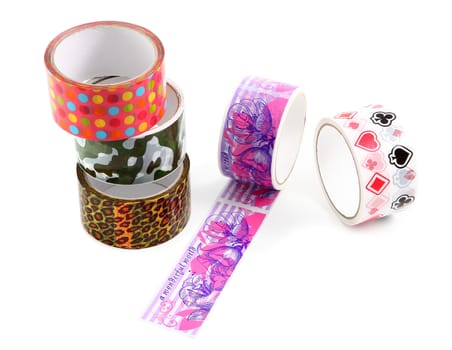 Set of several rolls of colored packing tape with colorful decorative print. Polka dot print, camouflage print, animal print, leopard print.
