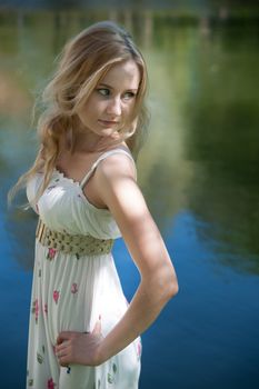 beautiful blonde near the water in the summer park