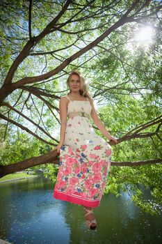 beautiful blonde near the water in the summer park