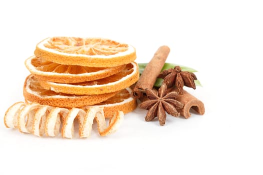 Dried orange, Star Anise, cinnamon and and green leave on white background