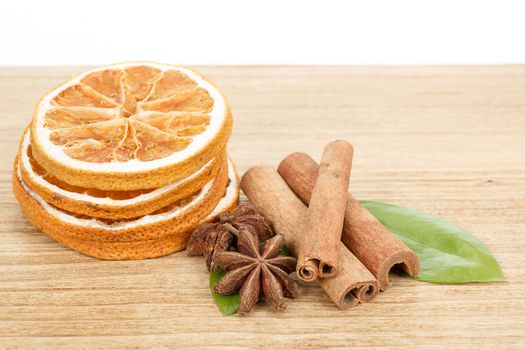 detail of Star Anise, cinnamon and dried orange  on wooden background 