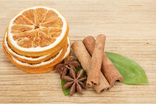 detail of Star Anise, cinnamon and dried orange  on wooden background 