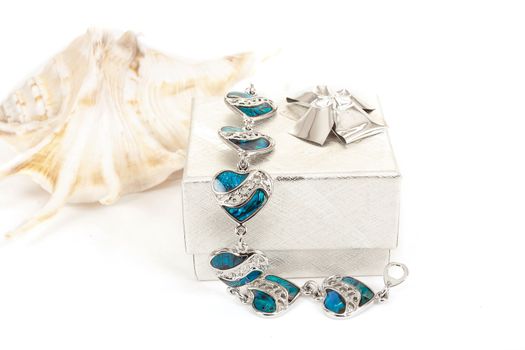 female bracelet with hearts and sea shell isolated on white 