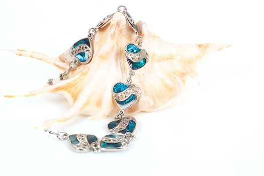 female bracelet with hearts and sea shell isolated on white 