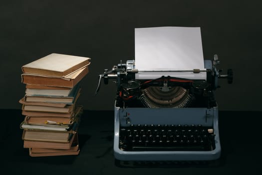 Old typewriter with paper and books, retro colors on the desk