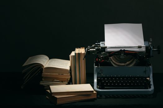 Old typewriter with paper and books, retro colors on the desk