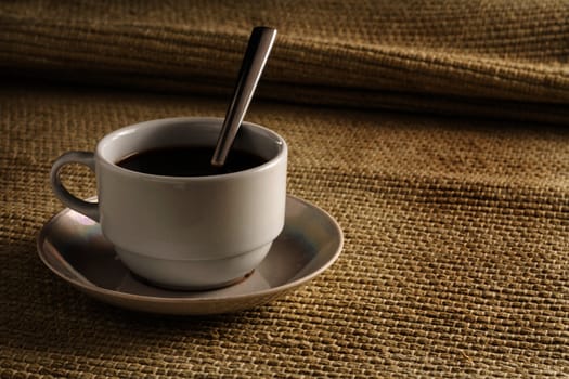A cup of black coffee on a yellow background in high resolution