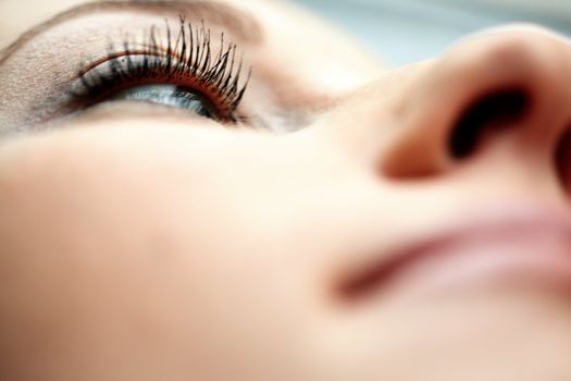 Close-up photo of the woman eye. Shallow depth of field due to the macro lens for purity effect