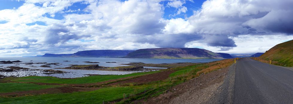 Highway through Iceland landscape at foggy day. Panorama