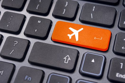 a plane sign on keyboard, to illustrate online booking or purchase of plane ticket or business travel concepts.