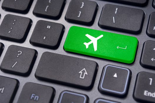 a plane sign on keyboard, to illustrate online booking or purchase of plane ticket or business travel concepts.