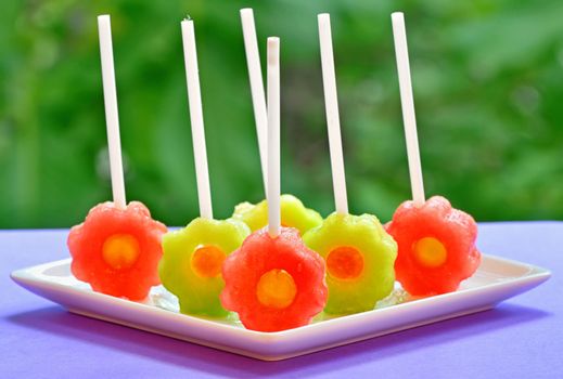 fruit pops of melon and watermelon on natural background