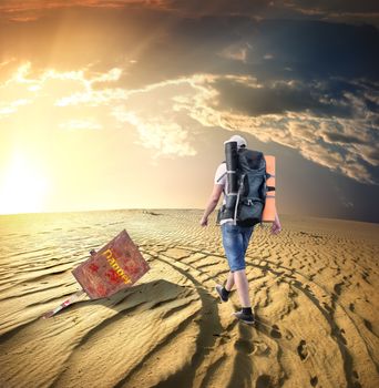 Man with a backpack traveling in the desert