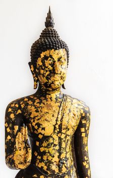 Black Buddha Statue covered with small Gold Plates isolated on White Background