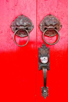 Red chinese door with a lion/dragon head.