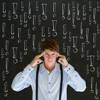 Thinking business man with chalk exclamation marks on blackboard background