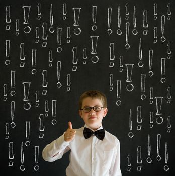 Thumbs up boy dressed up as business man with chalk exclamation marks on blackboard background