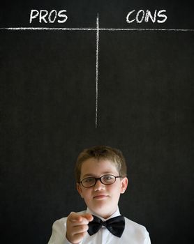Education needs you thinking boy dressed up as business man with chalk pros and cons decision list on blackboard background