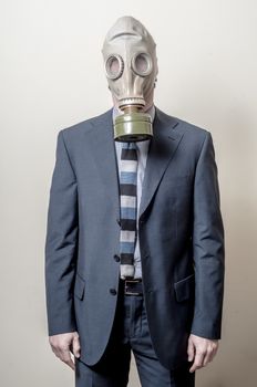 businessman with gas mask on gray background