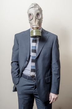 businessman with gas mask on gray background