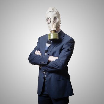 businessman with gas mask on gray background