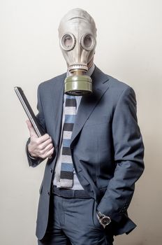 businessman with gas mask with notebook on gray background