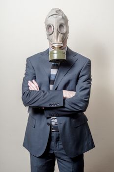 businessman with gas mask on gray background