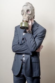 businessman with gas mask on gray background