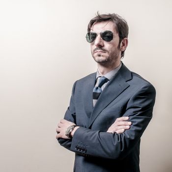 businessman serious with sunglasses on gray background