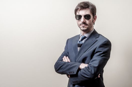 businessman serious with sunglasses on gray background