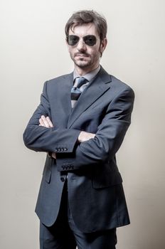 businessman serious with sunglasses on gray background