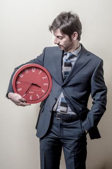 businessman with clock on gray background