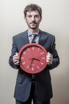 businessman with clock on gray background