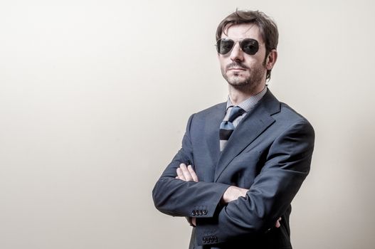 businessman serious with sunglasses on gray background