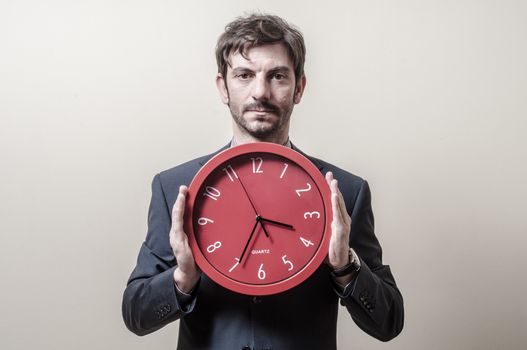 businessman with clock on gray background