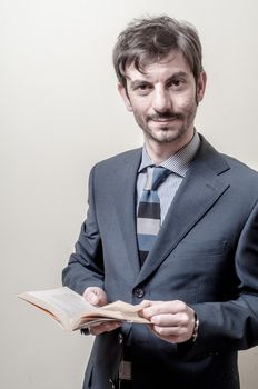 businessman reading book on gray background