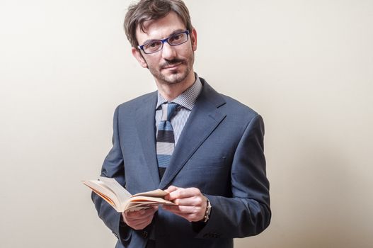 businessman reading book on gray background
