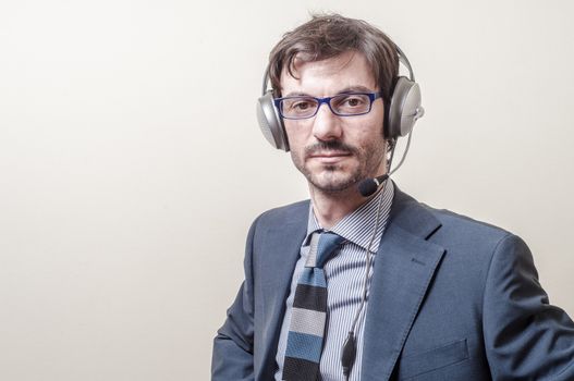 businessman with headphone and microphone on gray background